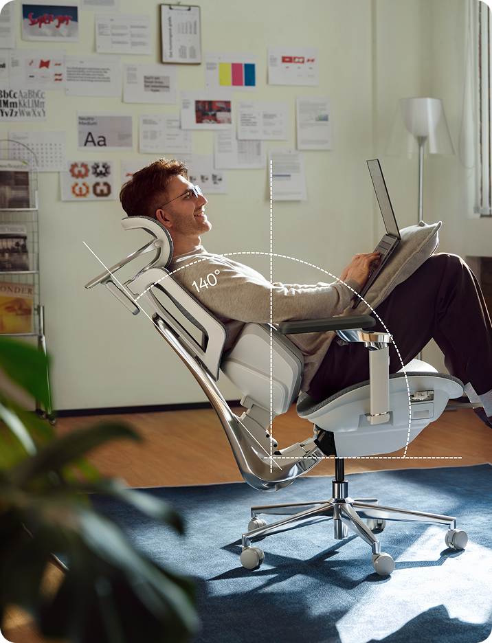 a man using a laptop sitting in Hbada X7 ergonomic office chiar