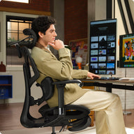 Man sitting on a black ergonomic chair in an e3 air ergonomic chair  ~scene